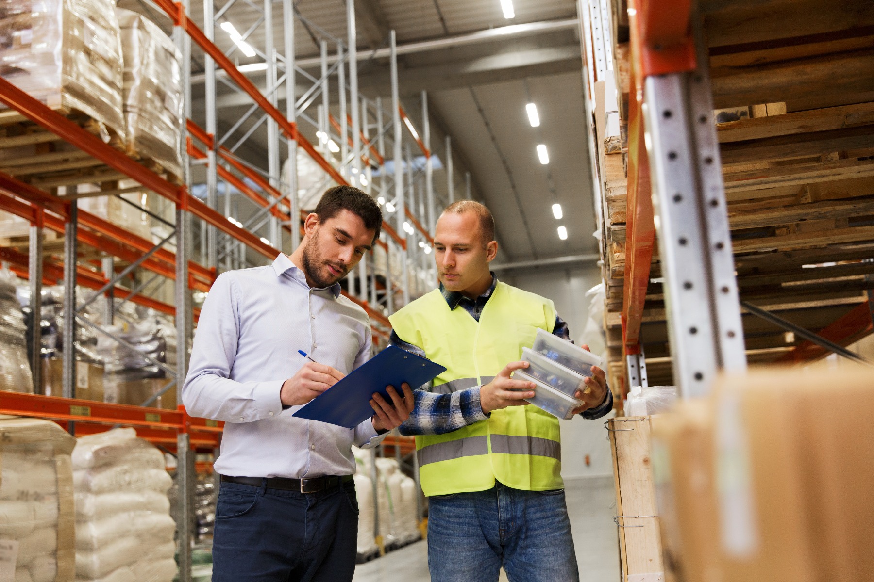 Two employees checking stock in warehouse